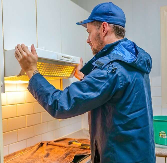 Range hood being fitted